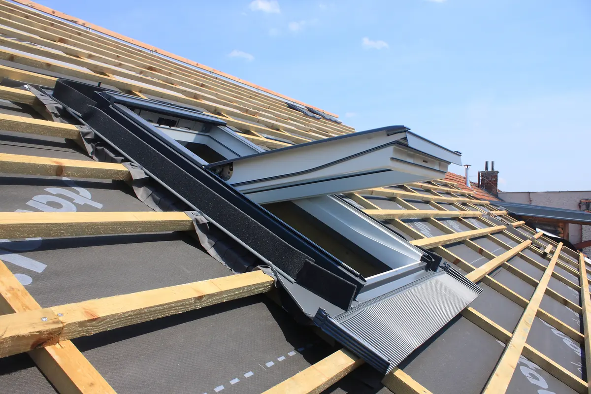 Roofer fitting a new roof window